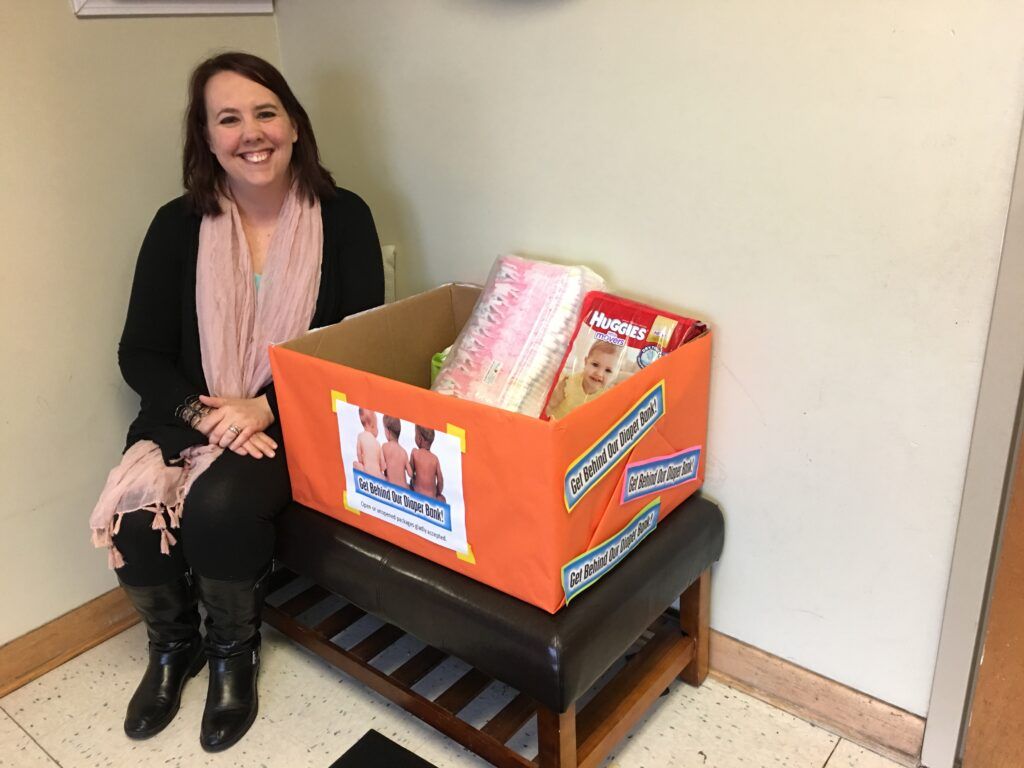 Pictured: Heather Schmidt, Assistant Director with the donation box. 